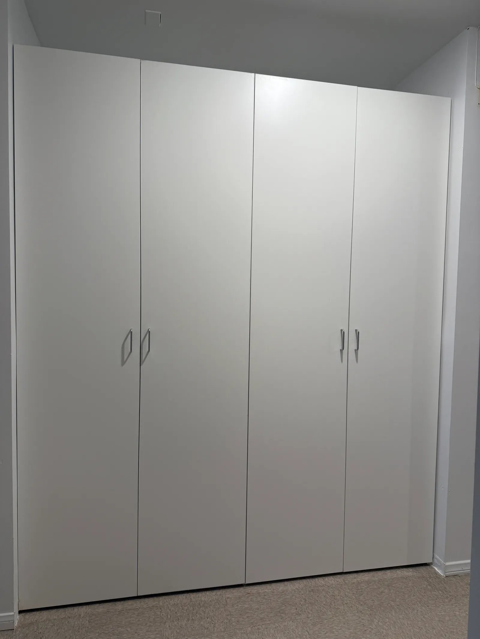 Custom white hallway storage system with full-height cabinetry in Glendale