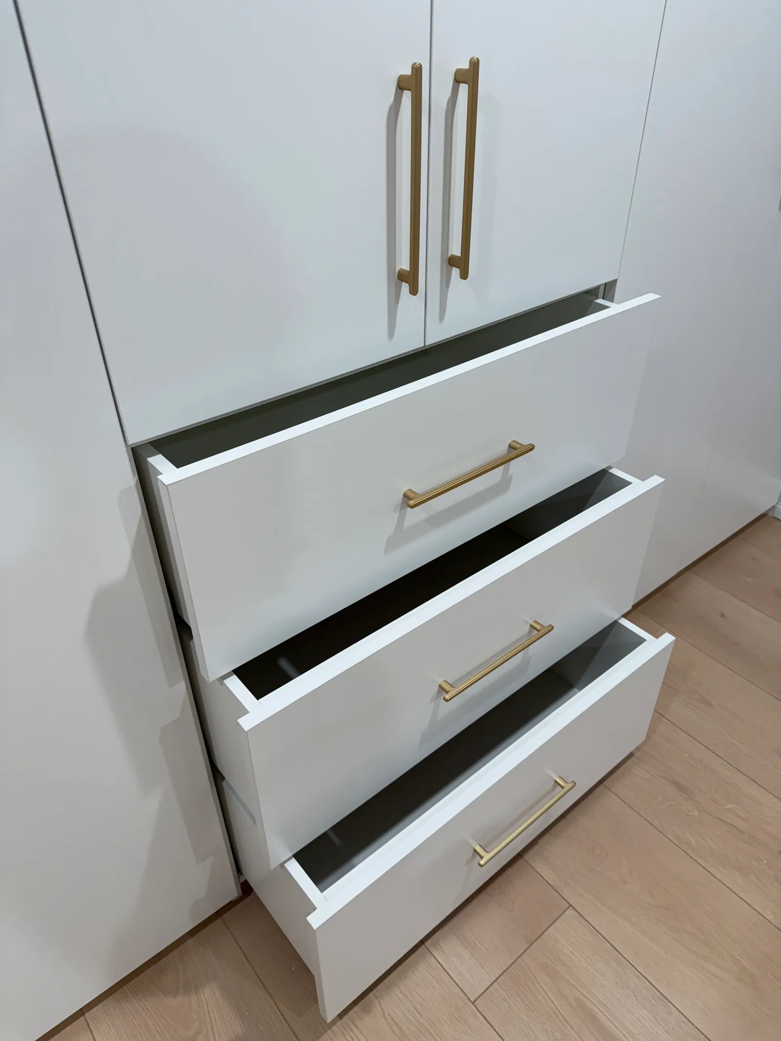 Custom white wardrobe drawers with metal handles in North Hollywood