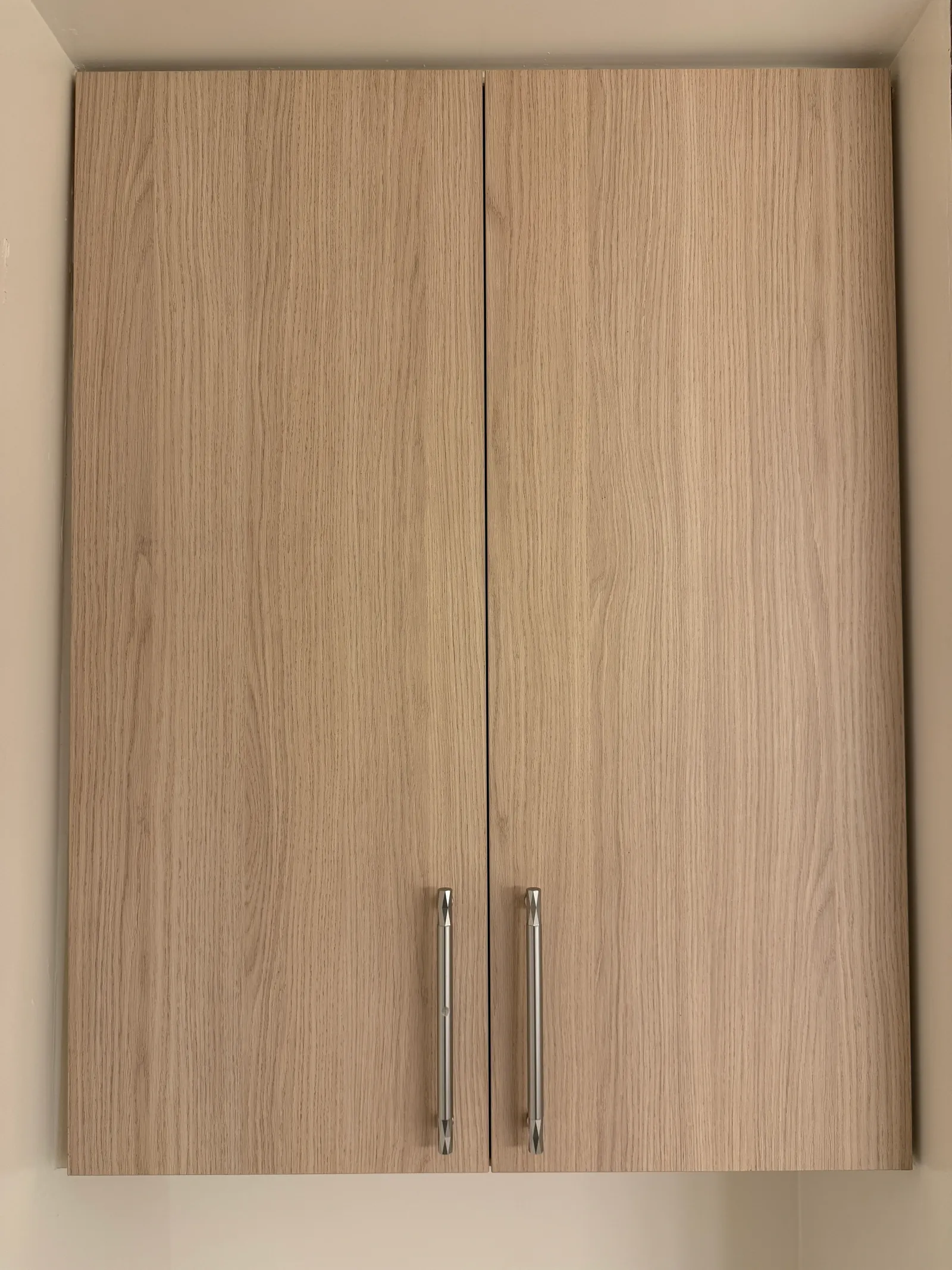 Matching wood-look storage cabinet on second wall of Tujunga wardrobe project
