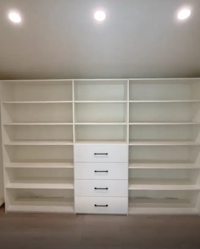 Custom white walk-in closet with open shelving and built-in drawers in Lake Balboa