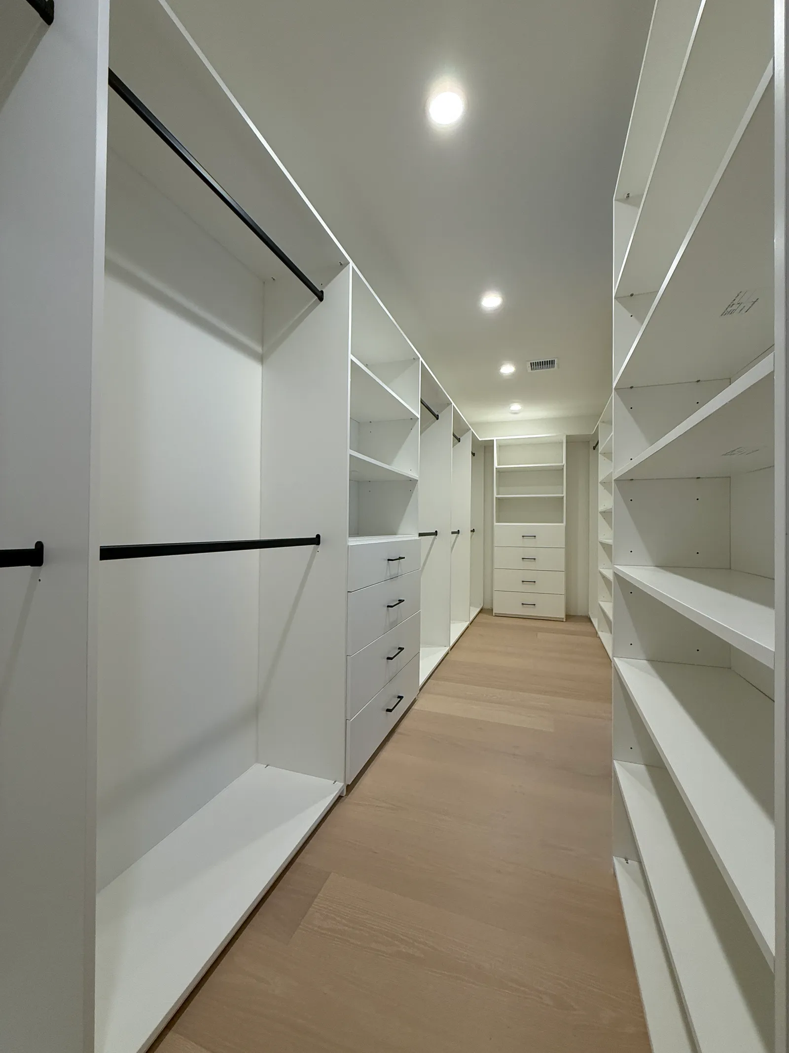 Custom walk-in closet with white melamine shelving and drawers in Sun Valley