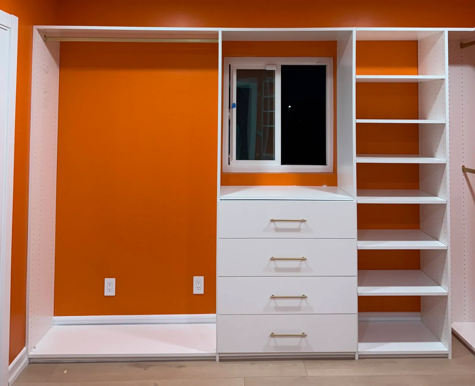 Custom walk-in closet with white melamine shelving and built-in drawers in North Hollywood