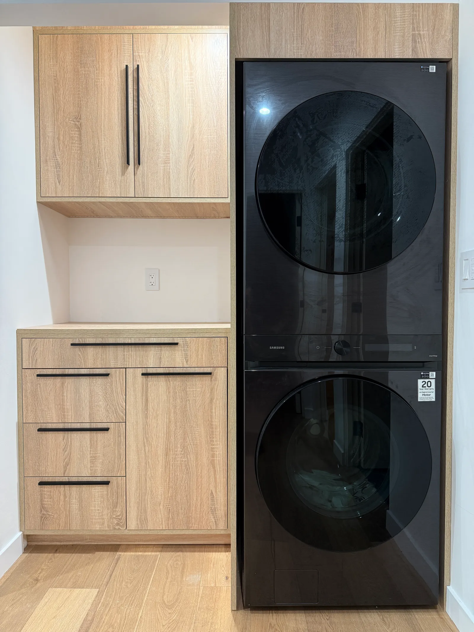 Oak-finish laundry cabinets with upper storage, drawers and a folding counter in La Crescenta