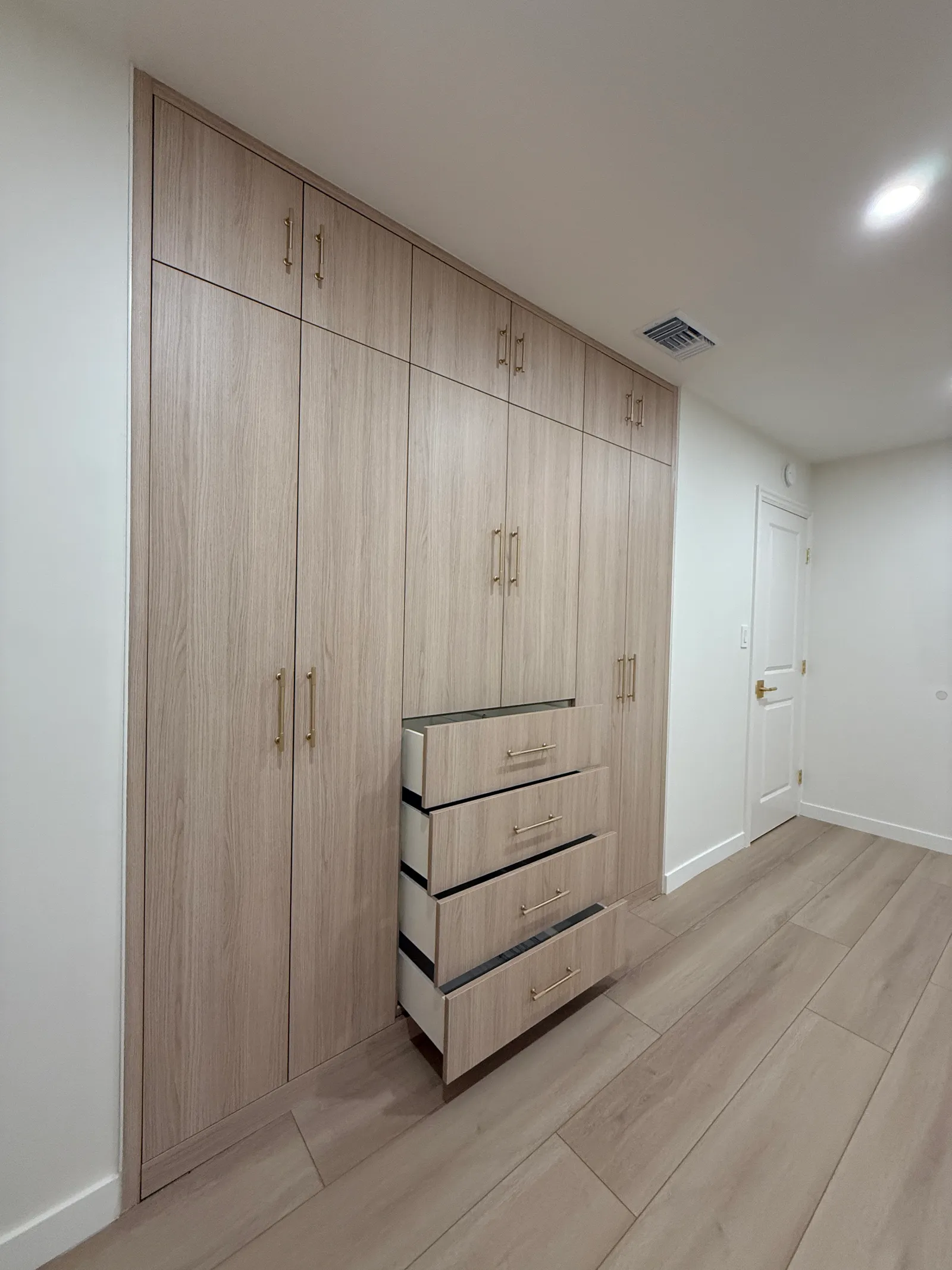 Full-height custom wardrobe with wood-look melamine finish in Tujunga