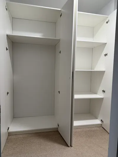 Interior shelving and tall storage compartment inside custom cabinetry