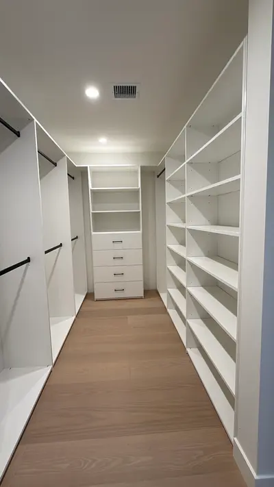 White melamine walk-in closet with hanging storage on both sides