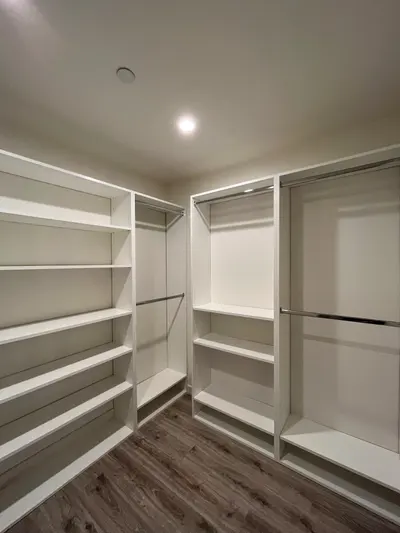 Adjustable shelving and hanging sections in a custom Reseda walk-in closet