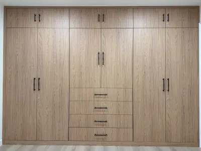 Custom full-wall wardrobe with wood-look melamine cabinetry in Tujunga