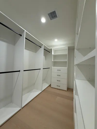 Custom closet storage with drawers, shelving, and double hanging sections