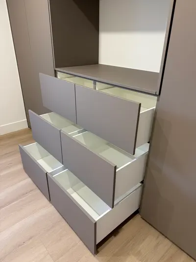 Detail of built-in drawers inside matte melamine cabinetry