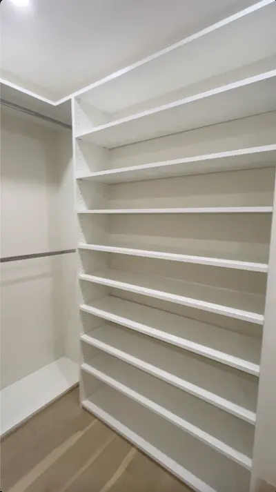 White adjustable shelving inside custom La Crescenta walk-in closet