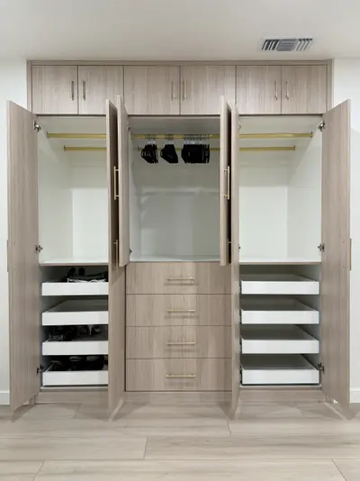 Custom wardrobe interior with hanging rods, shelving, and drawers
